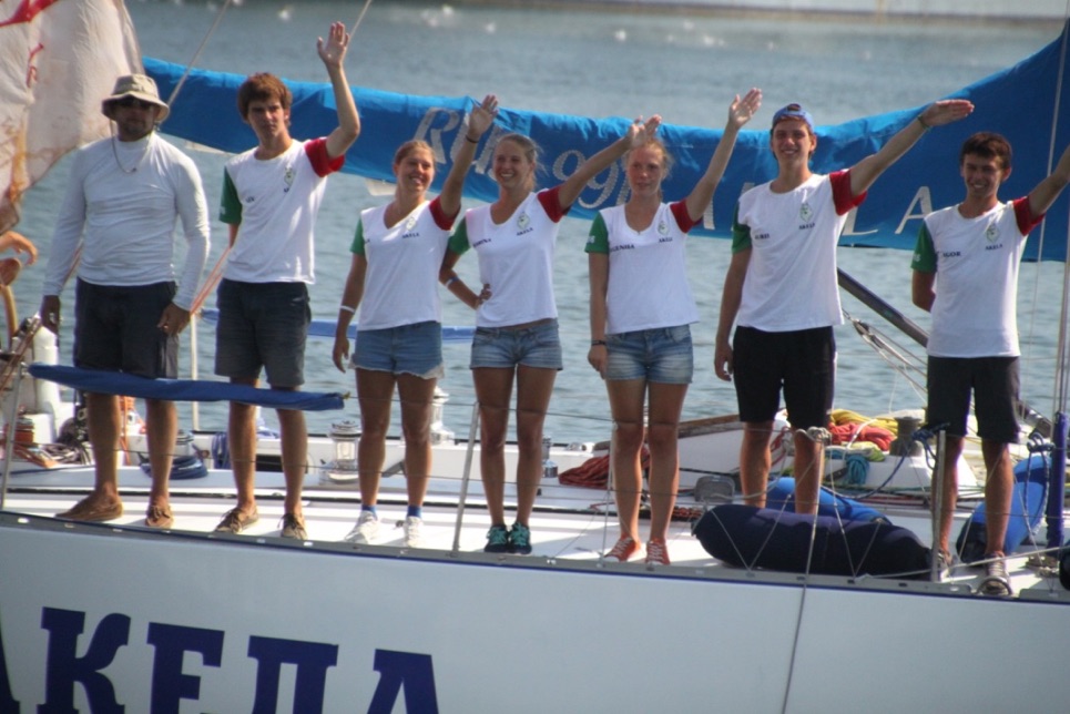 The crew of Akela waving goodbye to Constanta